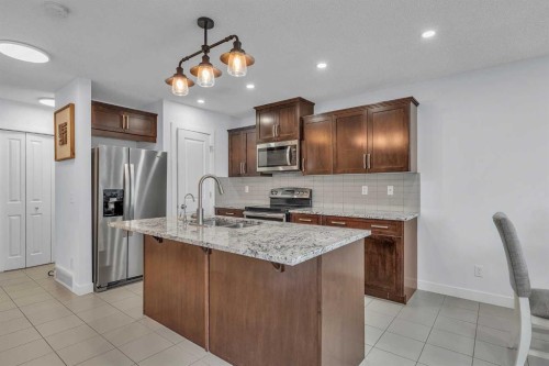 15 Kincora Crescent Nw, Calgary, AB - Indoor Photo Showing Kitchen With Stainless Steel Kitchen With Double Sink
