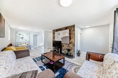 948 Rundlecairn Way Ne, Calgary, AB - Indoor Photo Showing Living Room With Fireplace