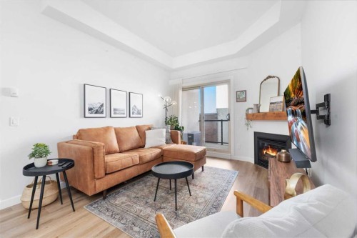407-488 7 Avenue Ne, Calgary, AB - Indoor Photo Showing Living Room With Fireplace