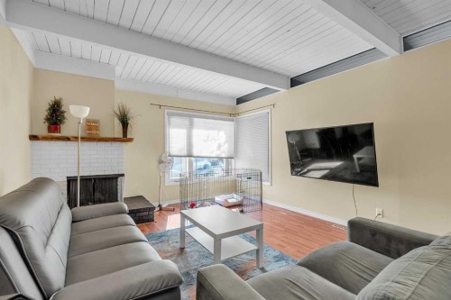 28 Hilton Avenue Nw, Calgary, AB - Indoor Photo Showing Living Room With Fireplace