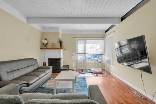 28 Hilton Avenue Nw, Calgary, AB - Indoor Photo Showing Living Room With Fireplace
