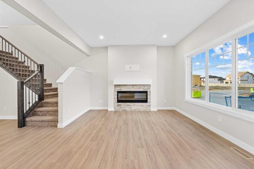 581 Baywater Manor Sw, Airdrie, AB - Indoor Photo Showing Living Room With Fireplace