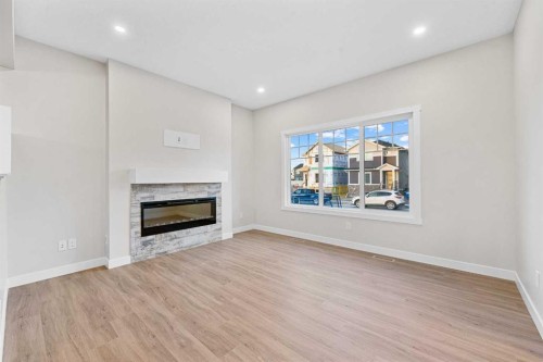 581 Baywater Manor Sw, Airdrie, AB - Indoor Photo Showing Living Room With Fireplace