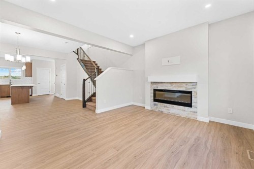 581 Baywater Manor Sw, Airdrie, AB - Indoor Photo Showing Living Room With Fireplace