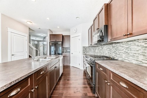 14 Heritage View, Cochrane, AB - Indoor Photo Showing Kitchen With Double Sink With Upgraded Kitchen