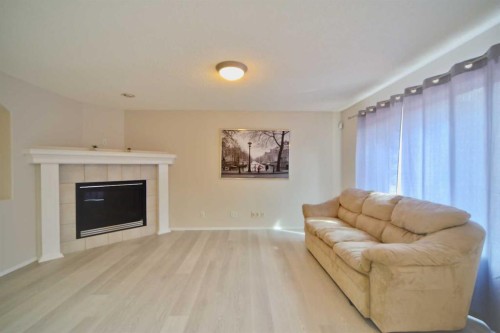 133 Panamount Court Nw, Calgary, AB - Indoor Photo Showing Living Room With Fireplace