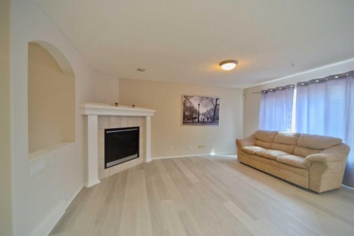 133 Panamount Court Nw, Calgary, AB - Indoor Photo Showing Living Room With Fireplace