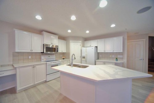 133 Panamount Court Nw, Calgary, AB - Indoor Photo Showing Kitchen With Double Sink