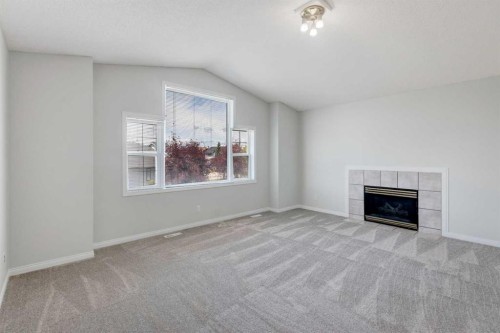 26 Rocky Ridge Heights Nw, Calgary, AB - Indoor Photo Showing Living Room With Fireplace