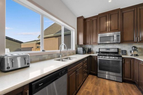 107 Masters Heights Se, Calgary, AB - Indoor Photo Showing Kitchen With Double Sink