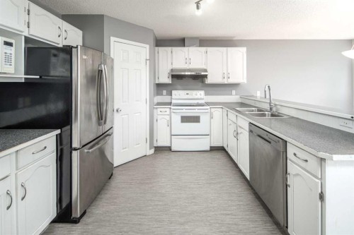 17 Hidden Creek Rise Nw, Calgary, AB - Indoor Photo Showing Kitchen With Double Sink