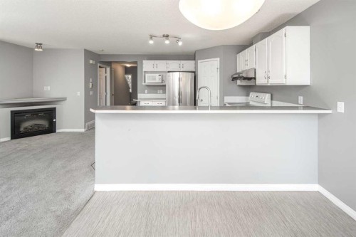 17 Hidden Creek Rise Nw, Calgary, AB - Indoor Photo Showing Kitchen With Fireplace