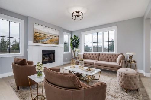 1209 Coopers Drive Sw, Airdrie, AB - Indoor Photo Showing Living Room With Fireplace
