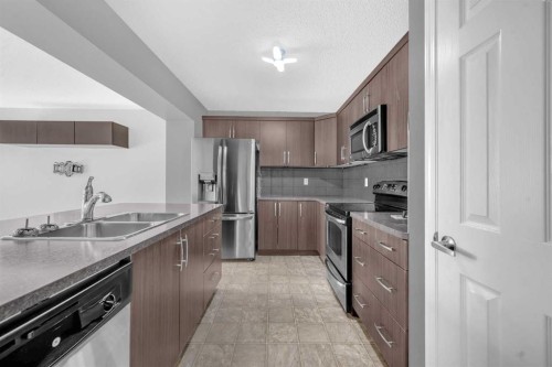 304 Windstone Gardens Sw, Airdrie, AB - Indoor Photo Showing Kitchen With Stainless Steel Kitchen With Double Sink With Upgraded Kitchen