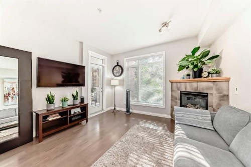 214-2 Hemlock Crescent Sw, Calgary, AB - Indoor Photo Showing Living Room With Fireplace