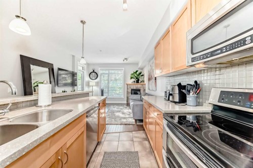214-2 Hemlock Crescent Sw, Calgary, AB - Indoor Photo Showing Kitchen With Double Sink