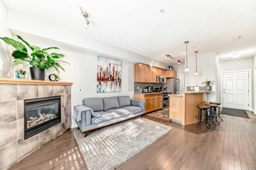 214-2 Hemlock Crescent Sw, Calgary, AB - Indoor Photo Showing Other Room With Fireplace