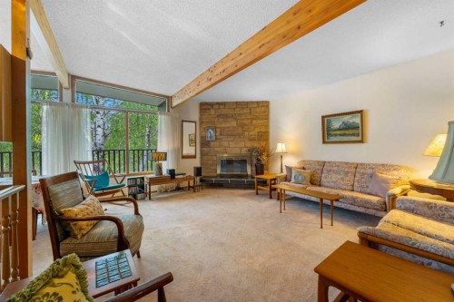 10 Varsville Place Nw, Calgary, AB - Indoor Photo Showing Living Room With Fireplace