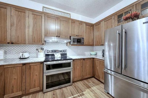 1233-151 Country Village Road Ne, Calgary, AB - Indoor Photo Showing Kitchen With Stainless Steel Kitchen