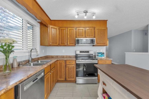 1318 Whitfield Avenue, Crossfield, AB - Indoor Photo Showing Kitchen With Double Sink