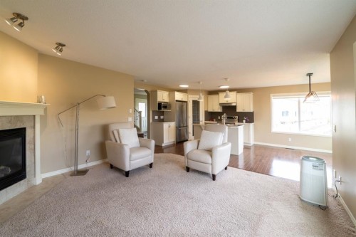 150 Tuscany Summit Heath Nw, Calgary, AB - Indoor Photo Showing Living Room With Fireplace