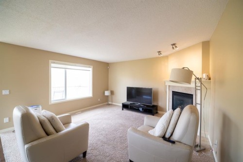 150 Tuscany Summit Heath Nw, Calgary, AB - Indoor Photo Showing Living Room With Fireplace