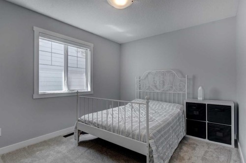 878 Bluerock Way Sw, Calgary, AB - Indoor Photo Showing Bedroom