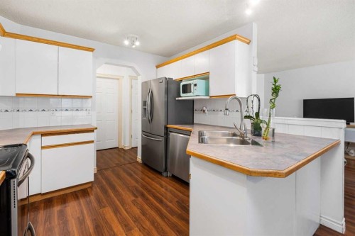85 Bridlewood Street Sw, Calgary, AB - Indoor Photo Showing Kitchen With Double Sink