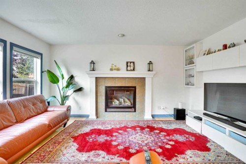 204 Covehaven Gardens Ne, Calgary, AB - Indoor Photo Showing Living Room With Fireplace