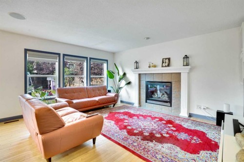 204 Covehaven Gardens Ne, Calgary, AB - Indoor Photo Showing Living Room With Fireplace