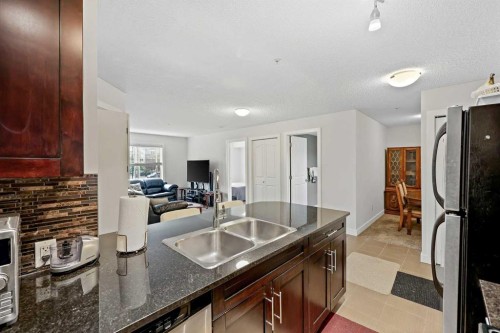 2212-403 Mackenzie Way Sw, Airdrie, AB - Indoor Photo Showing Kitchen With Double Sink