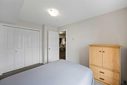 2212-403 Mackenzie Way Sw, Airdrie, AB - Indoor Photo Showing Bedroom