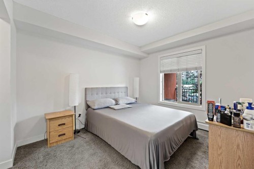 2212-403 Mackenzie Way Sw, Airdrie, AB - Indoor Photo Showing Bedroom