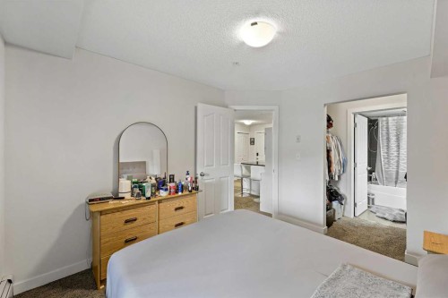 2212-403 Mackenzie Way Sw, Airdrie, AB - Indoor Photo Showing Bedroom