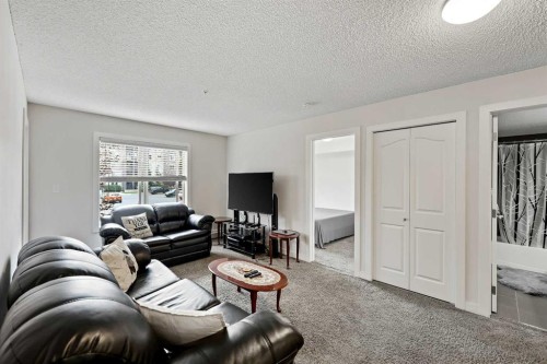 2212-403 Mackenzie Way Sw, Airdrie, AB - Indoor Photo Showing Living Room