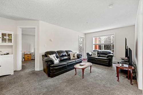 2212-403 Mackenzie Way Sw, Airdrie, AB - Indoor Photo Showing Living Room