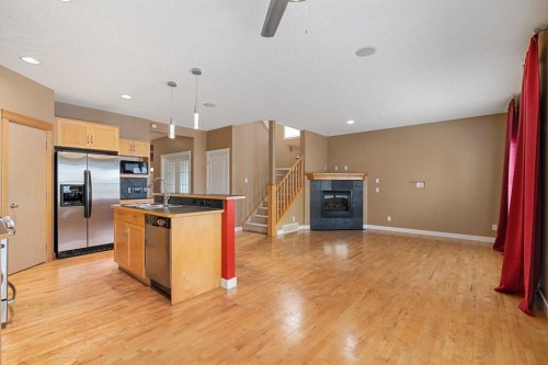 78 New Brighton Manor Se, Calgary, AB - Indoor Photo Showing Kitchen With Fireplace