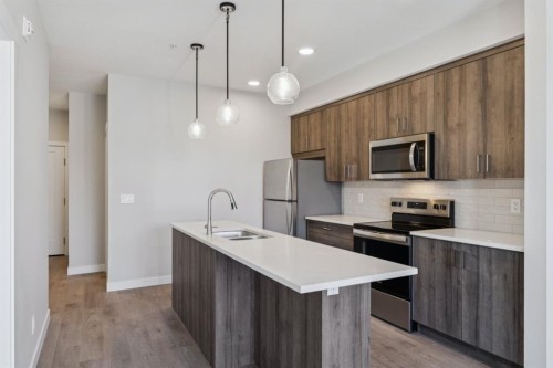 412-700 Shawnee Square Sw, Calgary, AB - Indoor Photo Showing Kitchen With Stainless Steel Kitchen With Double Sink With Upgraded Kitchen