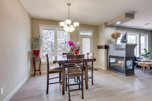 95 Evansdale Common Nw, Calgary, AB - Indoor Photo Showing Dining Room With Fireplace