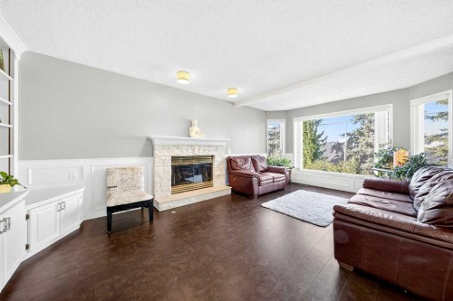1360 Shawnee Road Sw, Calgary, AB - Indoor Photo Showing Living Room With Fireplace