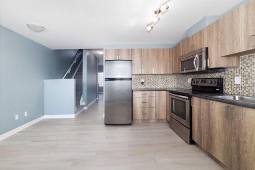 1218-121 Copperpond Common Se, Calgary, AB - Indoor Photo Showing Kitchen With Stainless Steel Kitchen