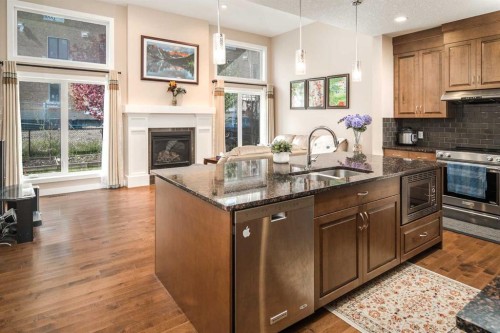 767 Shawnee Drive Sw, Calgary, AB - Indoor Photo Showing Kitchen With Fireplace With Double Sink With Upgraded Kitchen