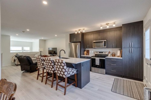 174 Chinook Gate Boulevard Sw, Airdrie, AB - Indoor Photo Showing Kitchen With Upgraded Kitchen