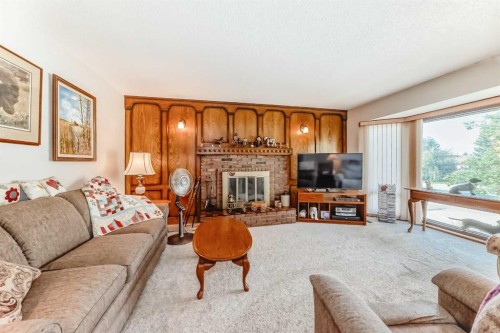 108 Jensen Place Ne, Airdrie, AB - Indoor Photo Showing Living Room With Fireplace