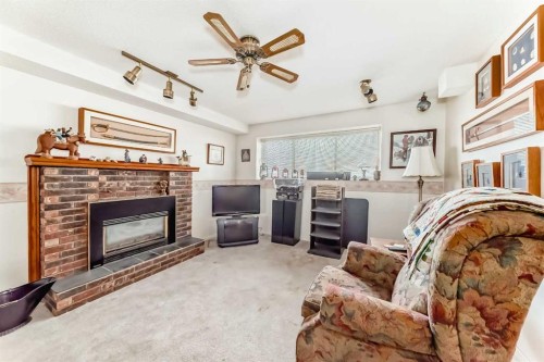 108 Jensen Place Ne, Airdrie, AB - Indoor Photo Showing Living Room With Fireplace