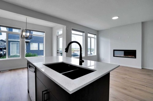 8 Corner Glen Row Ne, Calgary, AB - Indoor Photo Showing Kitchen With Fireplace With Double Sink