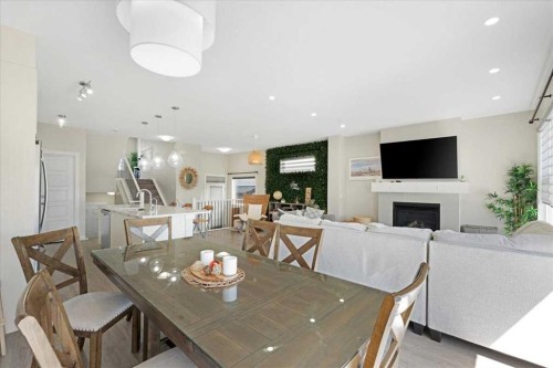 89 Sage Bluff Rise Nw, Calgary, AB - Indoor Photo Showing Dining Room With Fireplace