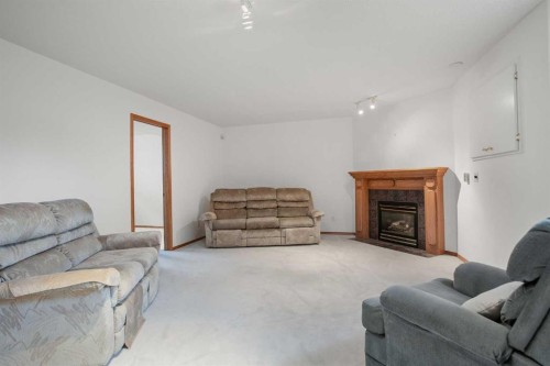 70 Anaheim Green Ne, Calgary, AB - Indoor Photo Showing Living Room With Fireplace