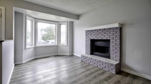 124 Riverbrook Way Se, Calgary, AB - Indoor Photo Showing Living Room With Fireplace