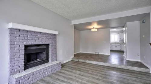 124 Riverbrook Way Se, Calgary, AB - Indoor Photo Showing Living Room With Fireplace